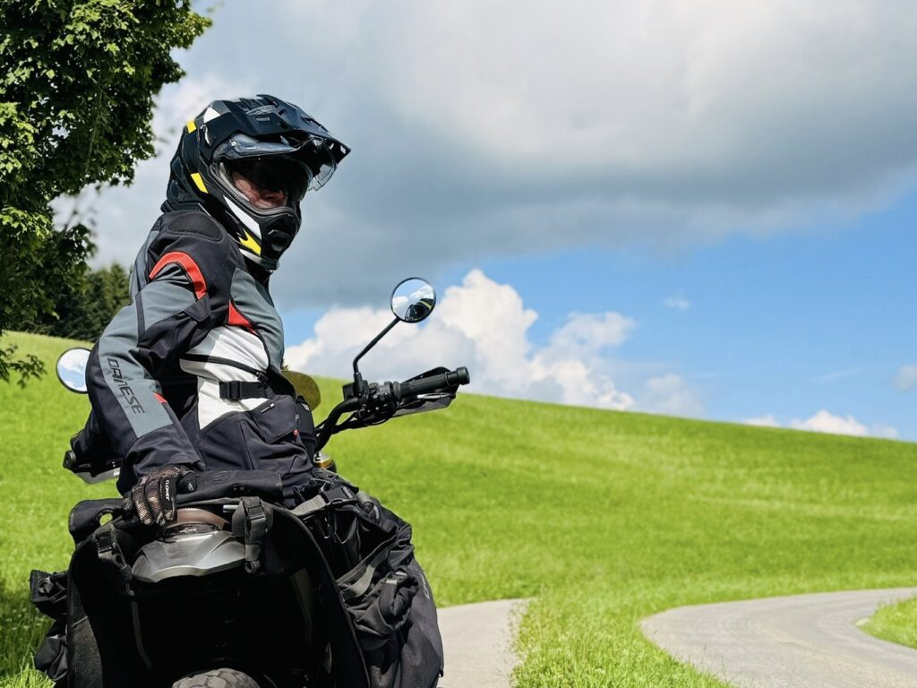 Motorcyclist taking a break with a view over the Emmental countryside.