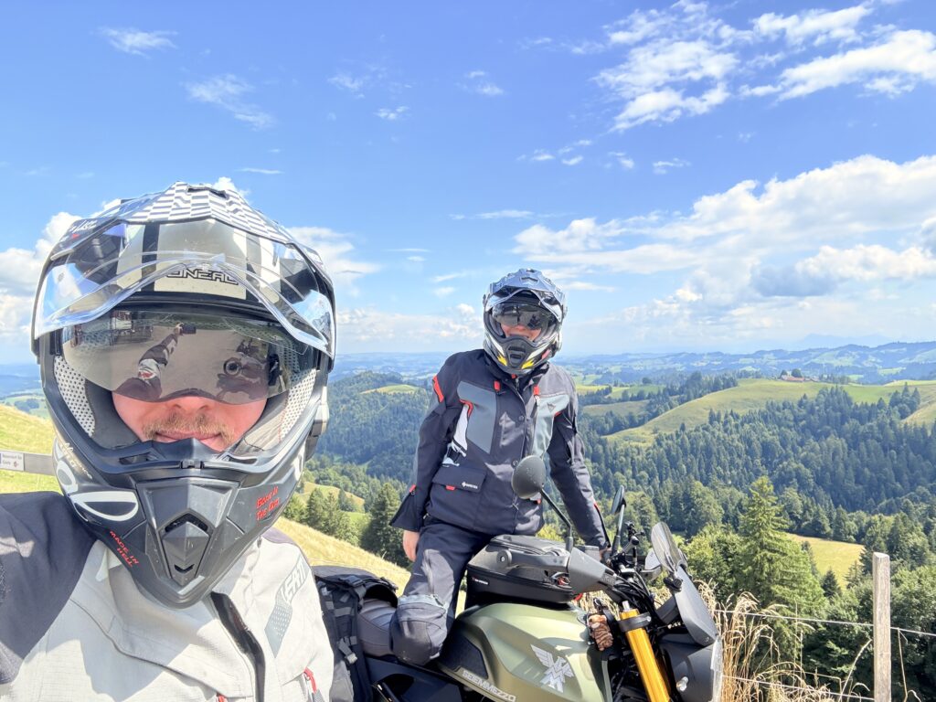 Riders overlooking the landscape from Emmental toward the Bernese Oberland.