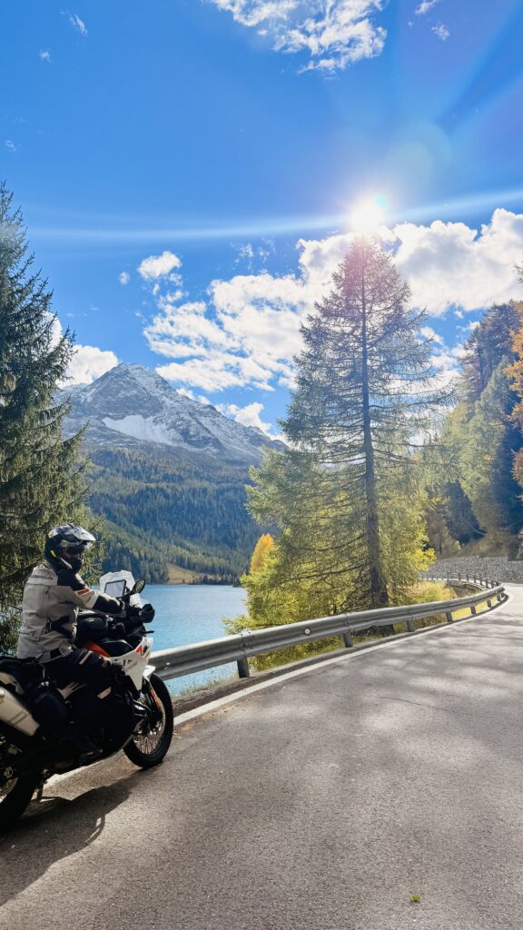 Motorcycle riding along a lake in South Tyrol, Italy