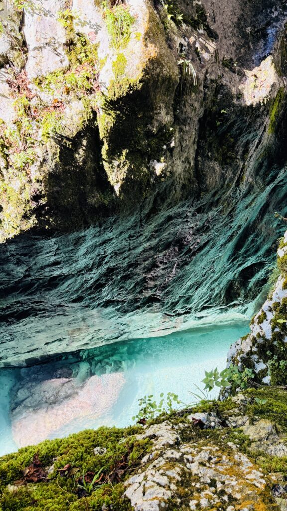 Clear emerald water flowing through Tolmin Gorge